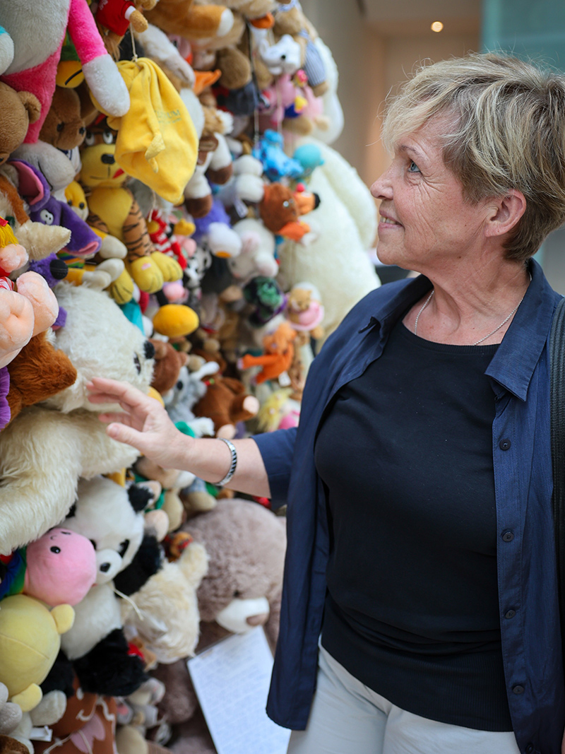 Eine Besucherin betrachtet die Kuscheltier-Installation